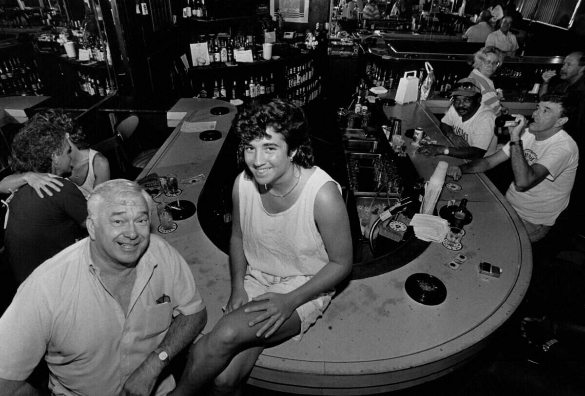 Katie Wardenski, 24, tends bar at Club Deuce. Left is regular Joe Onda, 55, who has been coming to the bar for 26 years.