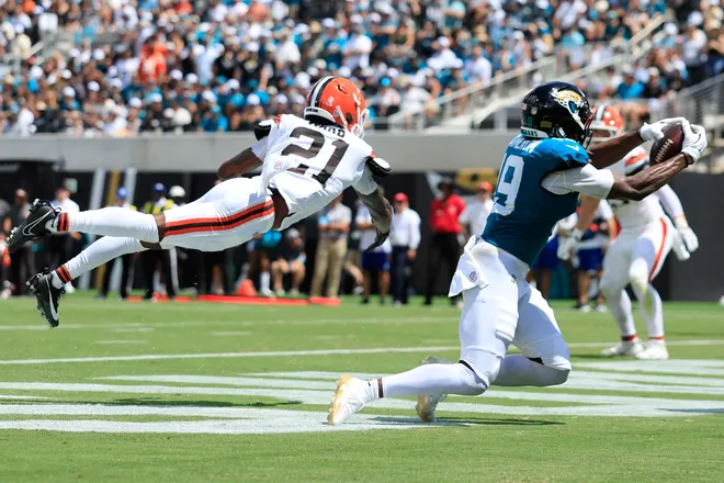 Jacksonville Jaguars wide receiver Josh Cameron (19) hauls in a touchdown reception against Cleveland Browns cornerback Denzel Ward (21) during the first quarter of an NFL football matchup at EverBank Stadium on Sunday, Sept. 13, 2026, in Jacksonville, Fla. [Corey Perrine/Florida Times-Union]