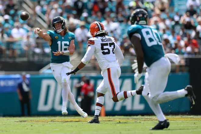 Sep 13, 2026; Jacksonville, Florida, USA; Jacksonville Jaguars quarterback Trevor Lawrence (16) attempts a pass to tight end Quintin Morris (80) under pressure from Cleveland Browns defensive end Isaiah McGuire (57) in the second quarter at EverBank Stadium. Mandatory Credit: Nathan Ray Seebeck-Imagn Images