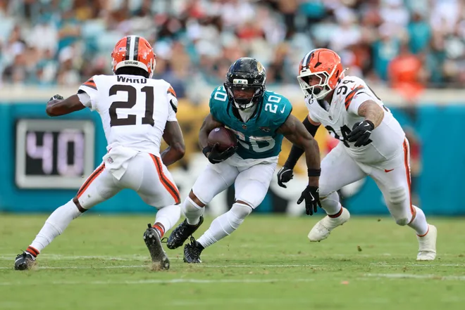Sep 13, 2026; Jacksonville, Florida, USA; Jacksonville Jaguars running back Ameer Abdullah (20) runs the ball against Cleveland Browns cornerback Denzel Ward (21) and defensive tackle Mason Graham (94) in the third quarter at EverBank Stadium. Mandatory Credit: Nathan Ray Seebeck-Imagn Images