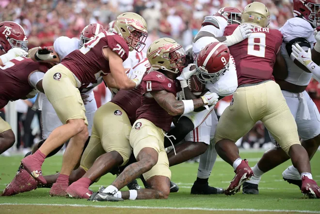 Aug 30, 2025; Tallahassee, Florida, USA; Alabama Crimson Tide running back Richard Young (9) runs with the ball against Florida State Seminoles defensive back Earl Little Jr. (0) during the first half at Doak S. Campbell Stadium. Mandatory Credit: Melina Myers-Imagn Images
