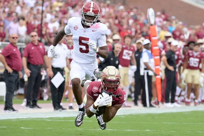 Aug 30, 2025; Tallahassee, Florida, USA; Florida State Seminoles wide receiver Squirrel White (4) makes a catch against Alabama Crimson Tide defensive back Dijon Lee Jr. (5) during the first half at Doak S. Campbell Stadium. Mandatory Credit: Melina Myers-Imagn Images