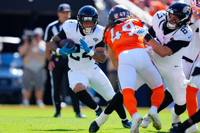 Sep 20, 2026; Denver, Colorado, USA;  Jacksonville Jaguars running back Chris Rodriguez Jr. (24) carries the ball against the Jacksonville Jaguars during the first half at Empower Field at Mile High.  Mandatory Credit: Ron Chenoy-Imagn Images