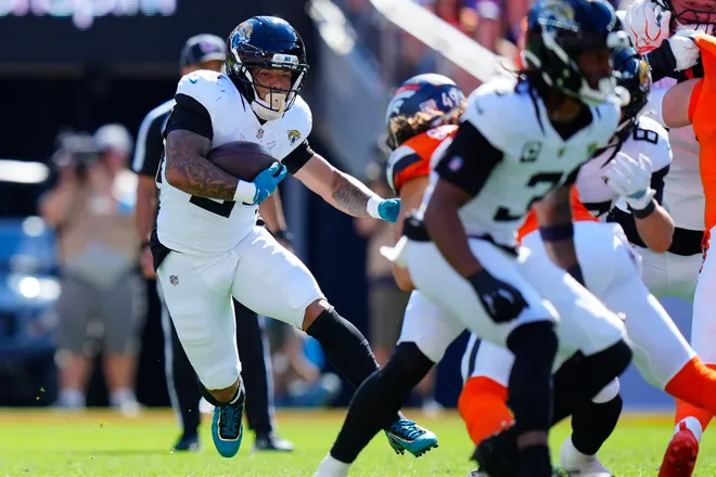 Sep 20, 2026; Denver, Colorado, USA;  Jacksonville Jaguars running back Chris Rodriguez Jr. (24) carries the ball during the third quarter against the Denver Broncos at Empower Field at Mile High.  Mandatory Credit: Ron Chenoy-Imagn Images