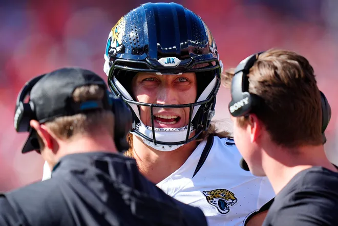 Sep 20, 2026; Denver, Colorado, USA;  Jacksonville Jaguars quarterback Trevor Lawrence (16) talks with the coaching staff during the first half against the Denver Broncos at Empower Field at Mile High.  Mandatory Credit: Ron Chenoy-Imagn Images