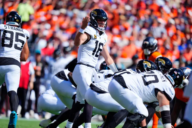 Sep 20, 2026; Denver, Colorado, USA;  Jacksonville Jaguars quarterback Trevor Lawrence (16) calls a play at the line of scrimmage against the Denver Broncos during the first quarter at Empower Field at Mile High.  Mandatory Credit: Ron Chenoy-Imagn Images