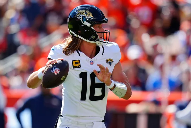 Sep 20, 2026; Denver, Colorado, USA;  Jacksonville Jaguars quarterback Trevor Lawrence (16) drops back to pass against the Denver Broncos in the first half at Empower Field at Mile High.  Mandatory Credit: Ron Chenoy-Imagn Images