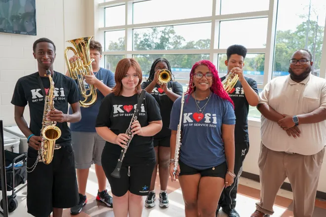 Riverside High School Band Director Isaac Green, right, and some of his music students show new instruments donated by Mr. Holland’s Opus Foundation. The nonprofit gave th school $38,500 worth of instruments.
