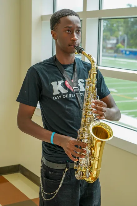 A Riverside High School music student tests out a new saxophone, one of about $38,500 worth of new instruments donated by Mr. Holland’s Opus Foundation.