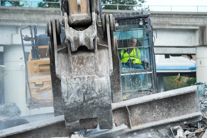 An excavator operator uses a steel girder to move debris from the teardown of First Baptist Church of Jacksonville’s old sanctuary in downtown Jacksonville, Fla., Wednesday, September 23, 2026.
