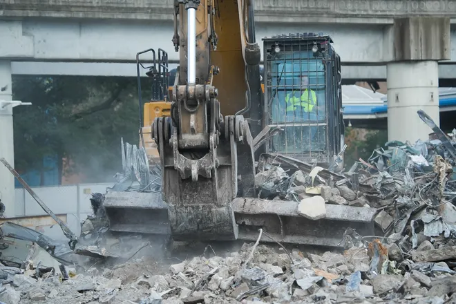 An excavator operator uses a steel girder to move debris from the tear down of the First Baptist Church of Jacksonville’s old sanctuary in downtown Jacksonville, Fla. Wednesday September 23, 2026.
