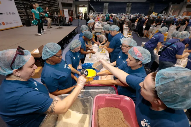 Volunteers gathered in the University of North Florida Arena in Jacksonville Sept. 11 for the 9/11 Day Meal Pack Event. The 9/11 Day nonprofit, which held similar events in 50 cities, wants to make each anniversary into "America’s largest day of unity and service."