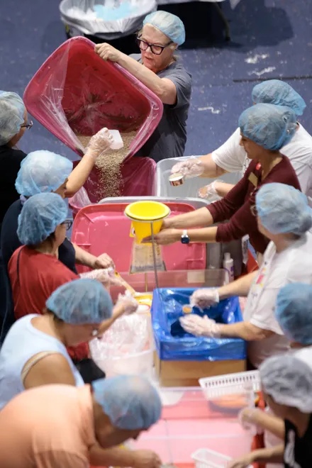 In assembly-line fashion, volunteers pack meals for the Feeding Northeast Florida food bank on Sept. 11. They were among 50,000 volunteers in 50 cities who packed at least 17 million meals for 9/11 Day, a nonprofit initiative to make 9/11 a day of service