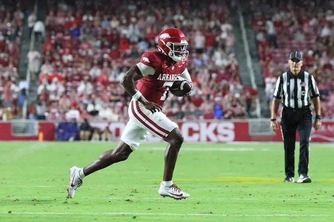 Sep 26, 2026; Fayetteville, Arkansas, USA; Arkansas Razorbacks quarterback KJ Jackson (7) rushes for a touchdown during the first quarter against the Tulsa Golden Hurricanes at Donald W. Reynolds Razorback Stadium. Mandatory Credit: Nelson Chenault-Imagn Images