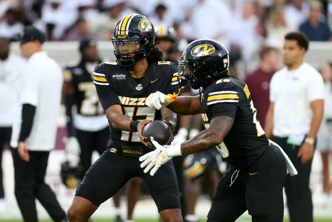 Sep 26, 2026; Starkville, Mississippi, USA; Missouri Tigers quarterback Austin Simmons (13) hands the ball off to running back Jamal Roberts (20) during warm ups prior to the game against the Mississippi State Bulldogs at Davis Wade Stadium at Scott Field. Mandatory Credit: Petre Thomas-Imagn Images