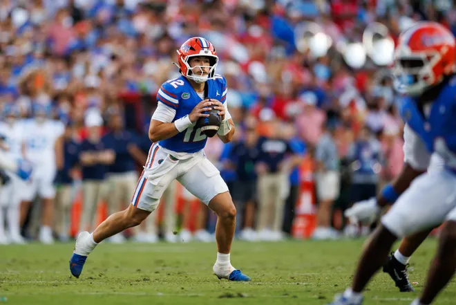 Sep 26, 2026; Gainesville, Florida, USA; Florida Gators quarterback Aaron Philo (12) looks to throw on the move against the Mississippi Rebels during the second half at Ben Hill Griffin Stadium. Mandatory Credit: Matt Pendleton-Imagn Images