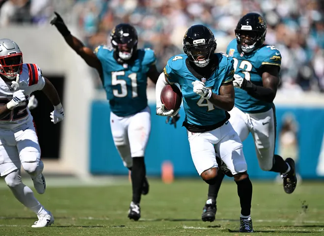 Sep 27, 2026; Jacksonville, Florida, USA; Jacksonville Jaguars cornerback Jarrian Jones (4) intercepts a pass during the third quarter against the New England Patriots at EverBank Stadium. Mandatory Credit: Melina Myers-Imagn Images