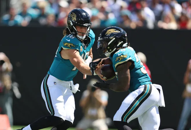 Sep 27, 2026; Jacksonville, Florida, USA; Jacksonville Jaguars quarterback Trevor Lawrence (16) hands the ball off to running back Bhayshul Tuten (33) during the first quarter against the New England Patriots at EverBank Stadium. Mandatory Credit: Morgan Tencza-Imagn Images