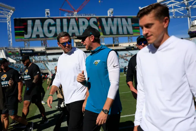 From left, Jacksonville Jaguars Executive Vice President of football operations Tony Boselli, head coach Liam Coen and general manager James Gladstone walk off the field after the game of an NFL football matchup at EverBank Stadium on Sunday, Sept. 27, 2026, in Jacksonville, Fla. The Jaguars defeated the Patriots 35-6. [Corey Perrine/Florida Times-Union]