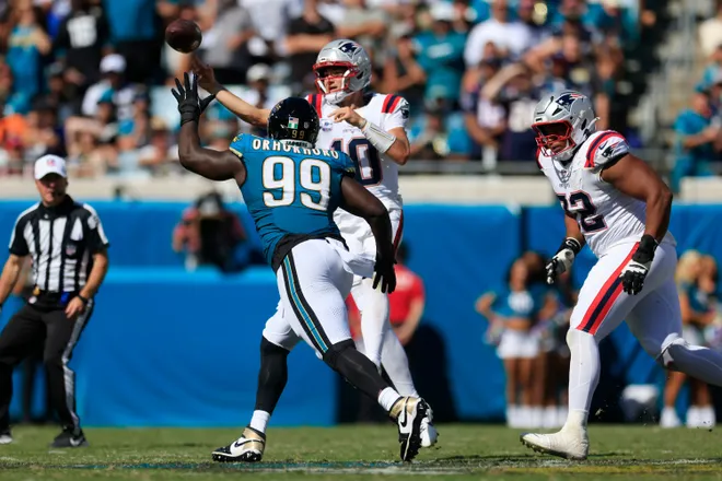 New England Patriots quarterback Drake Maye (10) is pressured by Jacksonville Jaguars defensive tackle Ruke Orhorhoro (99) during the fourth quarter of an NFL football matchup at EverBank Stadium on Sunday, Sept. 27, 2026, in Jacksonville, Fla. The Jaguars defeated the Patriots 35-6. [Corey Perrine/Florida Times-Union]