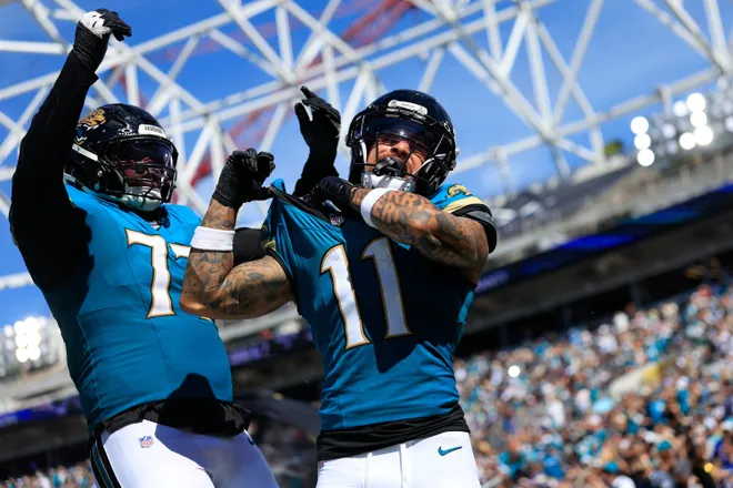 Jacksonville Jaguars wide receiver Parker Washington (11) celebrates on a touchdown that is called back with offensive tackle Anton Harrison (77) joining in during the third quarter of an NFL football matchup at EverBank Stadium on Sunday, Sept. 27, 2026, in Jacksonville, Fla. The Jaguars defeated the Patriots 35-6. [Corey Perrine/Florida Times-Union]