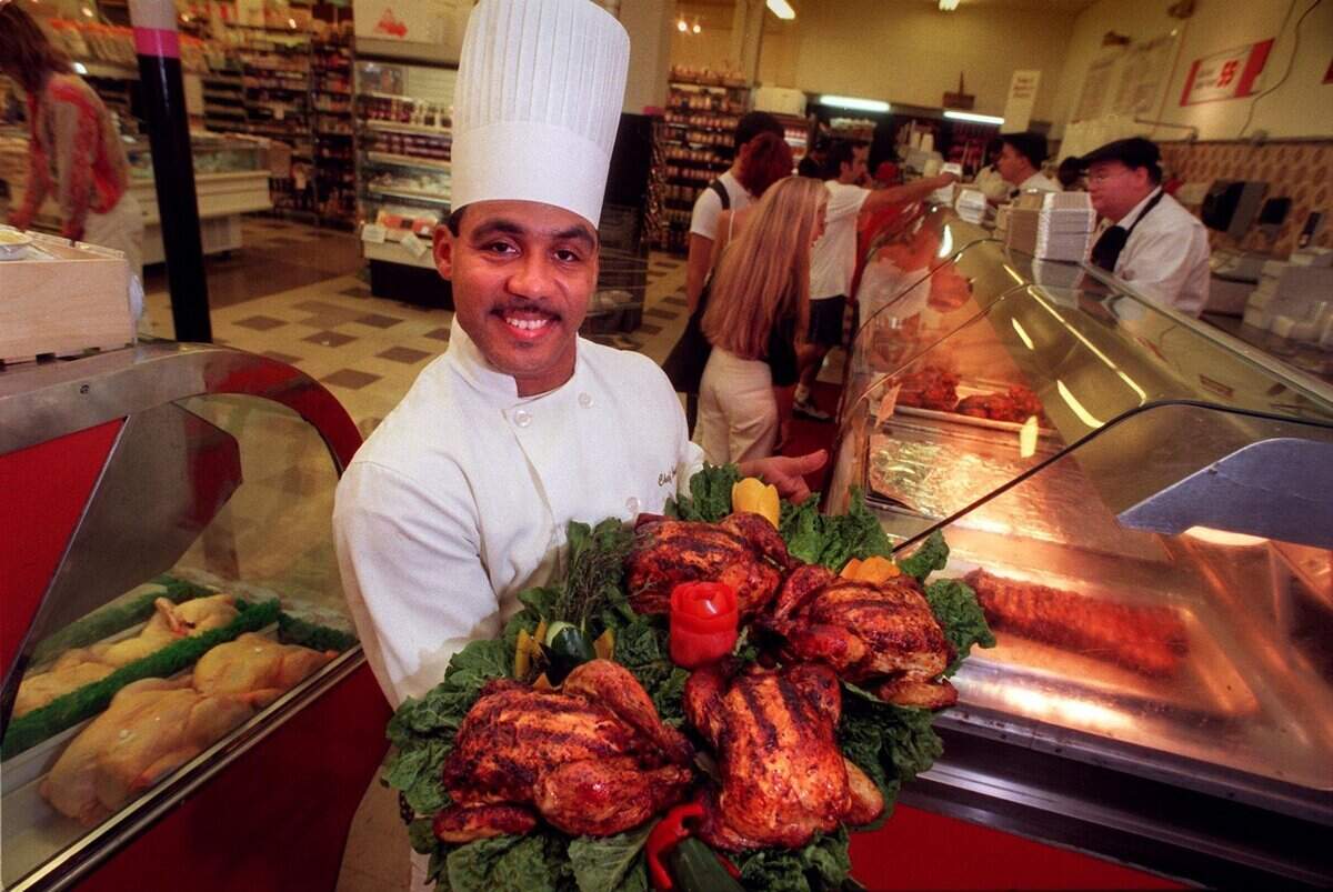 In 1998, Epicure chef Jose La-Bossiere holds a tray of roasted chickens at the Miami Beach Epicure.