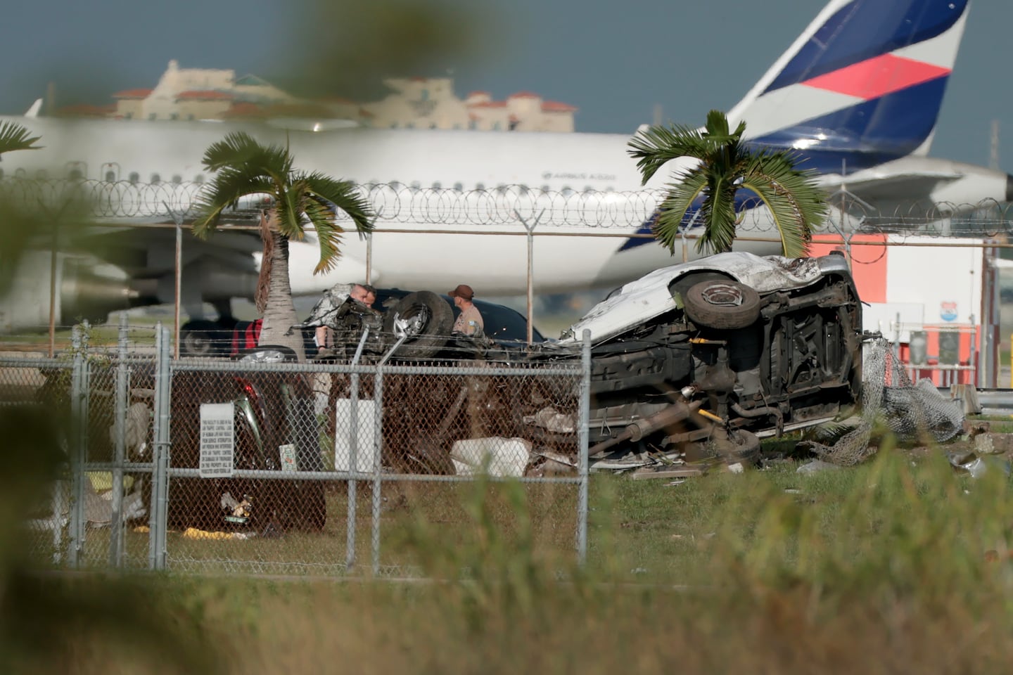 Investigators walk near damaged vehicles at Miami International Airport on Sept. 6, 2026 in Miami, Florida. The vehicles were damaged when an Amazon cargo plane crashed, with five people confirmed killed during the crash. According to the Federal Aviation Administration, Prime Air Flight 7598 overran the runway while landing around 2 p.m. after departing from Luis Muñoz Marín International Airport in San Juan, Puerto Rico.