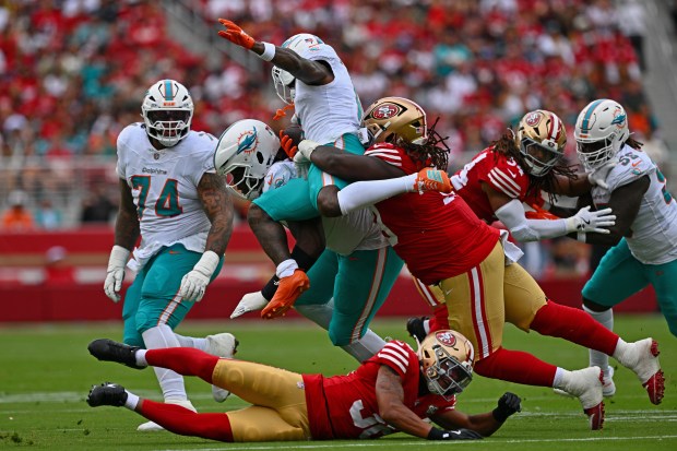 Miami Dolphins' Malik Washington (6) is tackled by San Francisco 49ers' CJ West (99) in mid-air in the first quarter of their NFL game at Levi's Stadium in Santa Clara, Calif., on Sunday, Sept. 20, 2026. (Jose Carlos Fajardo/Bay Area News Group)