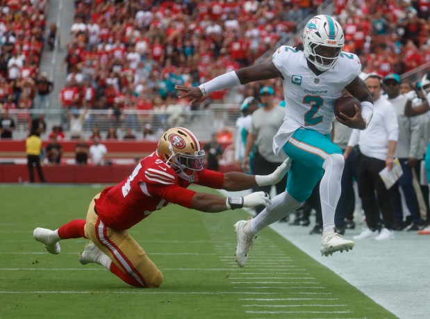 San Francisco 49ers' Romello Height (94) forces Miami Dolphins starting quarterback Malik Willis (2) out-of-bounds on third down in the second quarter at Levi's Stadium in Santa Clara, Calif., on Sunday, Sept. 20, 2026. (Nhat V. Meyer/Bay Area News Group)