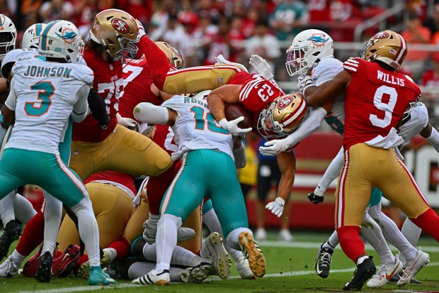 San Francisco 49ers' Christian McCaffrey (23) leaps into the end zone for a touchdown in the third quarter of their NFL game at Levi's Stadium in Santa Clara, Calif., on Sunday, Sept. 20, 2026. The San Francisco 49ers defeated the Miami Dolphins 35-13. (Jose Carlos Fajardo/Bay Area News Group)
