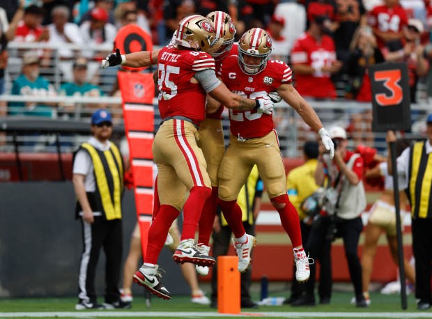 San Francisco 49ers' Kyle Juszczyk (44) celebrates his touchdown with San Francisco 49ers' George Kittle (85) and San Francisco 49ers' Christian McCaffrey (23) against the Miami Dolphins in the third quarter at Levi's Stadium in Santa Clara, Calif., on Sunday, Sept. 20, 2026. (Nhat V. Meyer/Bay Area News Group)