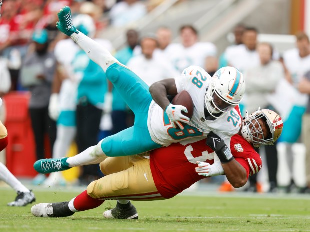 San Francisco 49ers' Gracen Halton (93) tackles Miami Dolphins' De'Von Achane (28) in the fourth quarter at Levi's Stadium in Santa Clara, Calif., on Sunday, Sept. 20, 2026. (Nhat V. Meyer/Bay Area News Group)