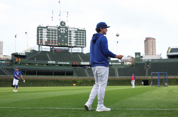 Cubs hitting development coach Ben Martin helps with players warming up before a game against the Marlins at Wrigley Field on Sept. 22, 2026, in Chicago. (John J. Kim/Chicago Tribune)