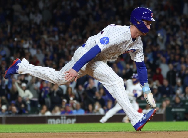Cubs center fielder Pete Crow-Armstrong dives for third base on a single from right fielder Seiya Suzuki in the sixth inning against the Marlins at Wrigley Field on Sept. 22, 2026, in Chicago. (John J. Kim/Chicago Tribune)