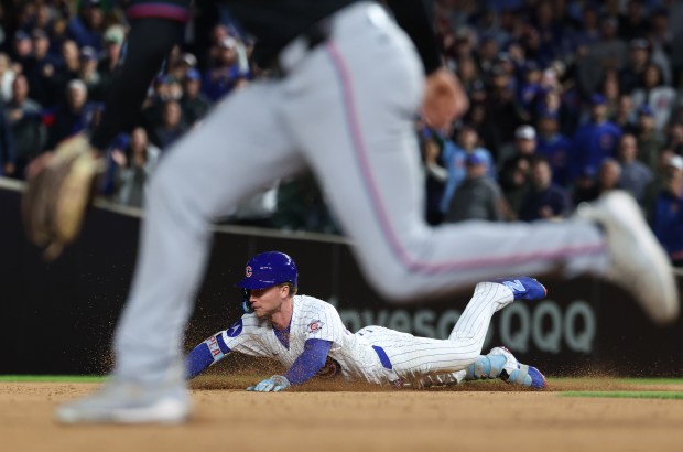 Cubs center fielder Pete Crow-Armstrong dives for second base on a double in the ninth inning against the Marlins at Wrigley Field on Sept. 22, 2026, in Chicago. (John J. Kim/Chicago Tribune)