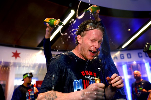 Pete Crow-Armstrong celebrates with teammates in the clubhouse after the Cubs clinched a playoff spot with a victory over the Marlins on Thursday, Sept. 24, 2026, at Wrigley Field. (Chris Sweda/Chicago Tribune)