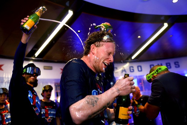 Pete Crow-Armstrong celebrates with teammates in the clubhouse after the Cubs clinched a playoff spot with a victory over the Marlins on Thursday, Sept. 24, 2026, at Wrigley Field. (Chris Sweda/Chicago Tribune)