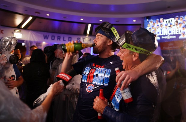 Cubs catcher Carson Kelly, center, celebrates with teammates in the clubhouse after the team clinched a playoff spot Thursday, Sept. 24, 2026, at Wrigley Field. (Chris Sweda/Chicago Tribune)