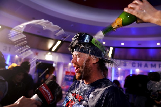 Carson Kelly celebrates with teammates in the clubhouse after the Cubs clinched a playoff spot Thursday, Sept. 24, 2026, at Wrigley Field. (Chris Sweda/Chicago Tribune)