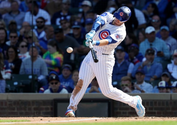 Cubs left fielder Ian Happ hits a triple in the sixth inning against the Marlins on Thursday, Sept. 24, 2026, at Wrigley Field. (Chris Sweda/Chicago Tribune)