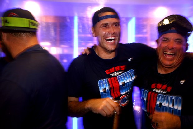 Cubs starter Matthew Boyd, center, celebrates with teammates in the clubhouse after clinching a playoff spot with a victory against the Marlins on Sept. 24, 2026, at Wrigley Field. (Chris Sweda/Chicago Tribune)