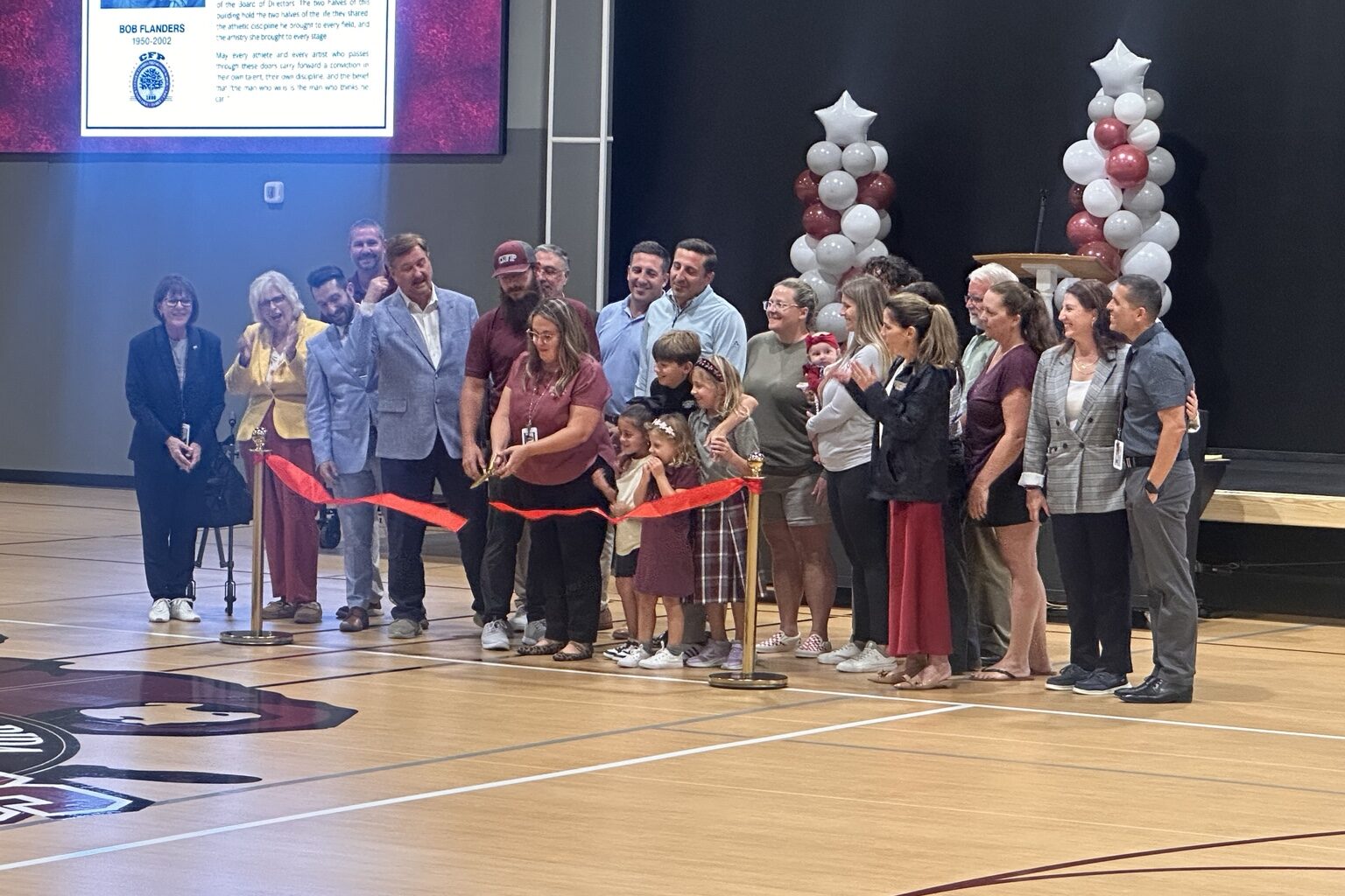 Central Florida Preparatory School head of school Julia Najera cuts the ribbon Friday, Aug. 28, to celebrate the opening of the Robert A. Flanders Athletic and Performing Arts Center. The 24,000-square-foot facility includes a gymnasium, classrooms and space for athletic, academic and performing arts programs.
