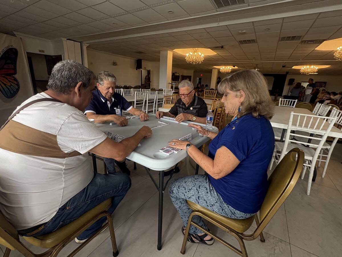 Hialeah seniors, from front, Eduardo Alfonso and Lazara Rodriguez, and in back, Raul Gonzalez and Edigio Vargas, play dominoes at Salon Tropical inside La Carreta, the new location of Little Havana Activities & Nutrition Centers after the city ended its 43-year operation at Goodlet Park.
