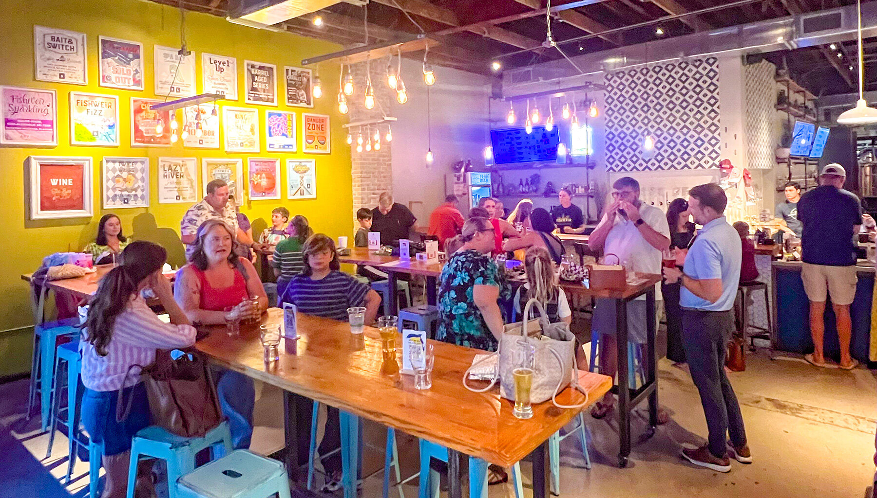 people sitting and talking inside Fishweir Brewery