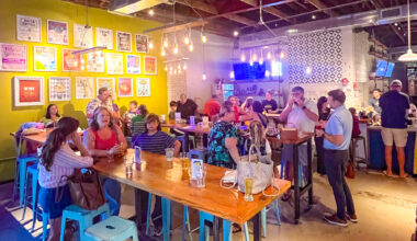 people sitting and talking inside Fishweir Brewery