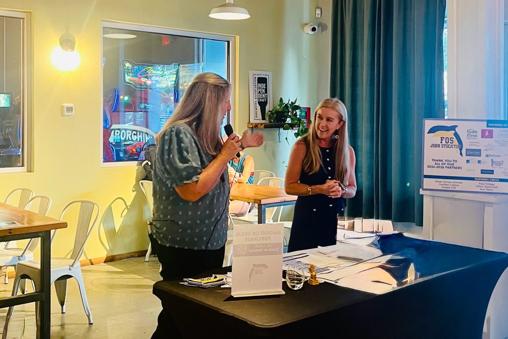 two women talking at display table
