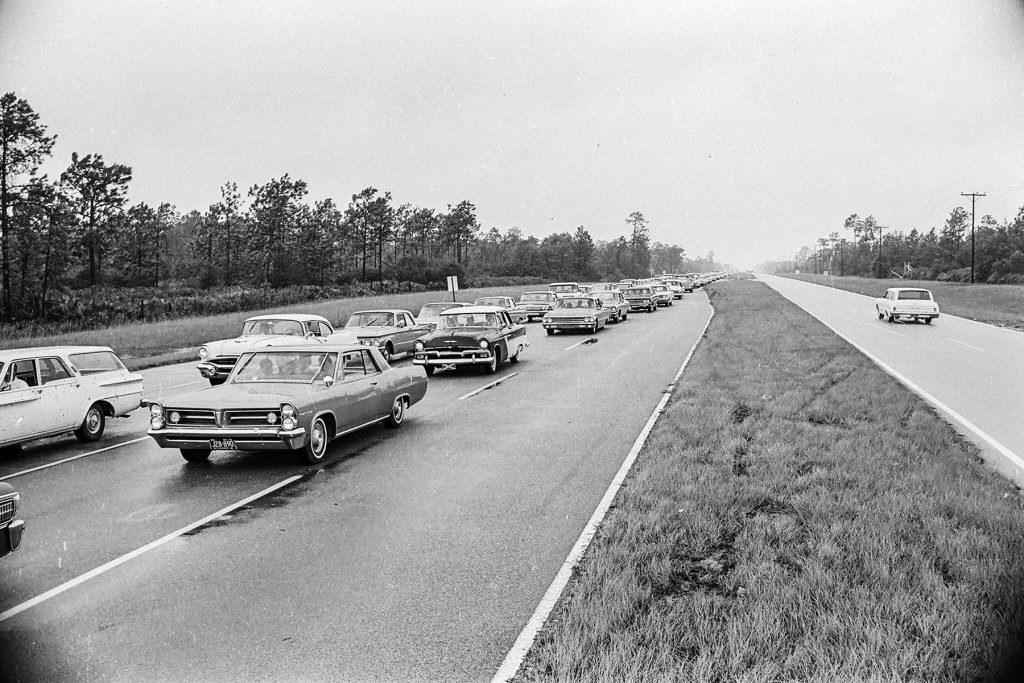 A lone vehicle heads toward Jacksonville as most of its residents flee in the other direction.
