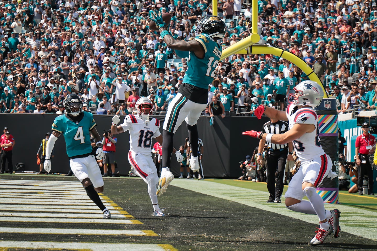 Jaguars cornerback Travis Hunter picked off a pass intended for Patriots wide receiver Efton Chism III (right) in the end zone.