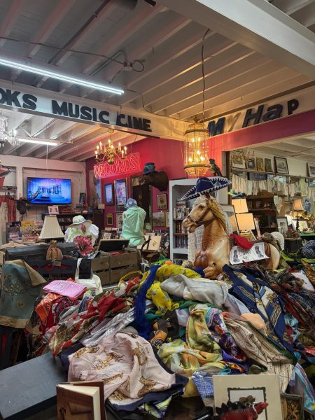 Black letters spelling out "Music" on the roof and a pile of multicolored clothes are in the middle of the image