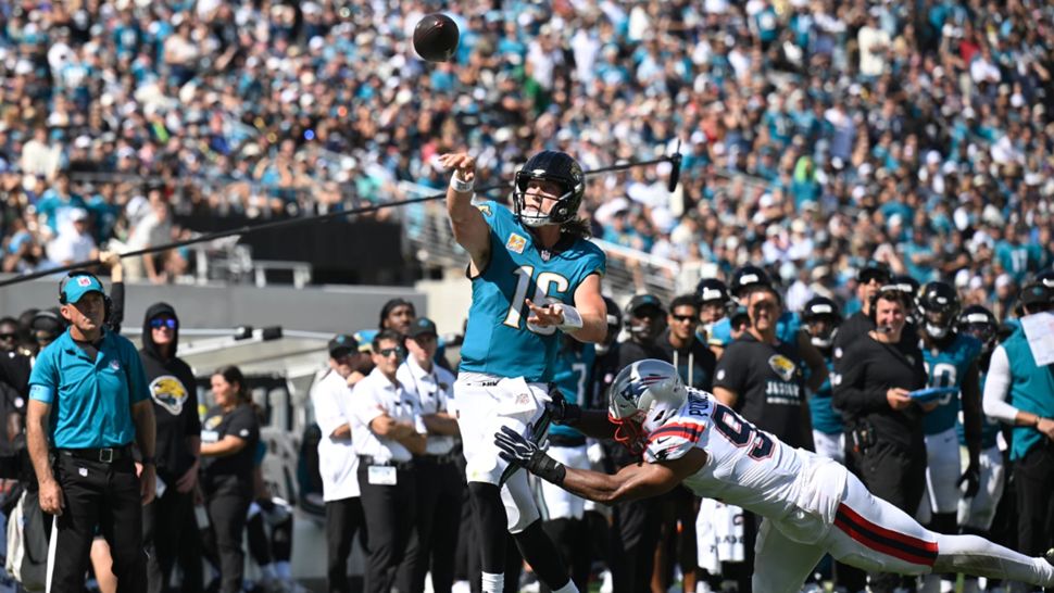Jacksonville Jaguars quarterback Trevor Lawrence (16) passes against New England Patriots linebacker Elijah Ponder (91) in the second half during an NFL football game in Jacksonville, Fla., Sunday, Sept. 27, 2026. (AP Photo/Phelan M. Ebenhack)
